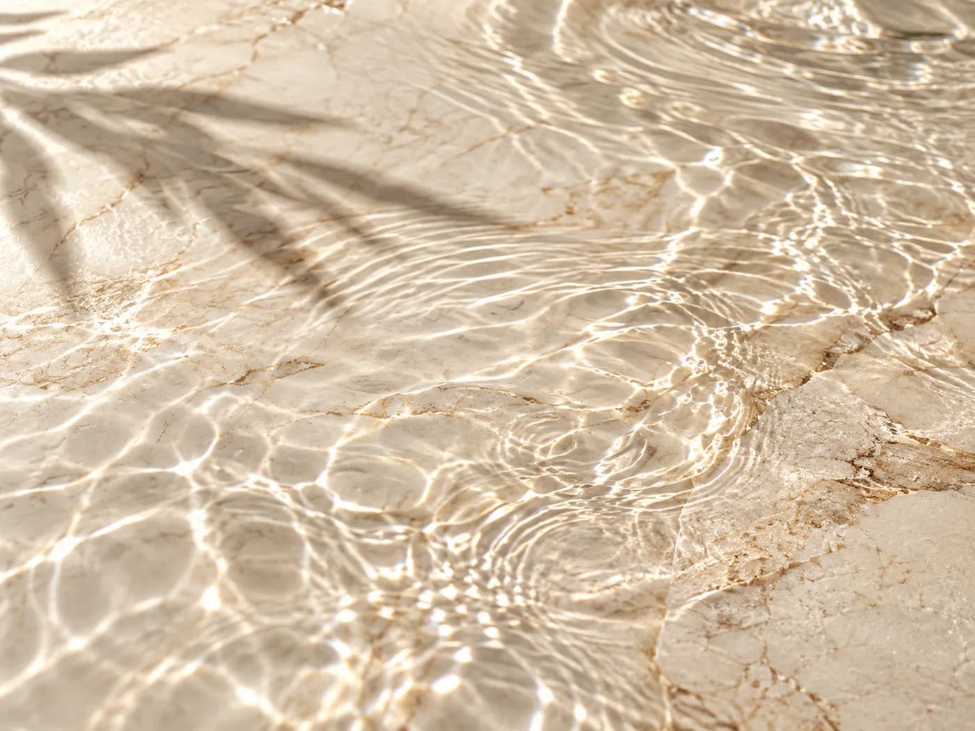 Decorative editorial image of clear water over pale stone